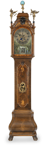 <b>Inlaid longcase clock in a two-part walnut case with carved figurative finials</b>