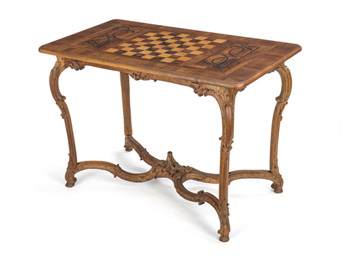 <b>A German carved walnut, maple and amaranth games table</b>