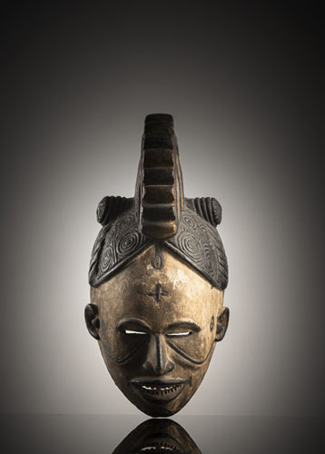 <b>A carved wood helmet mask</b> <b>A carved wood helmet mask</b>